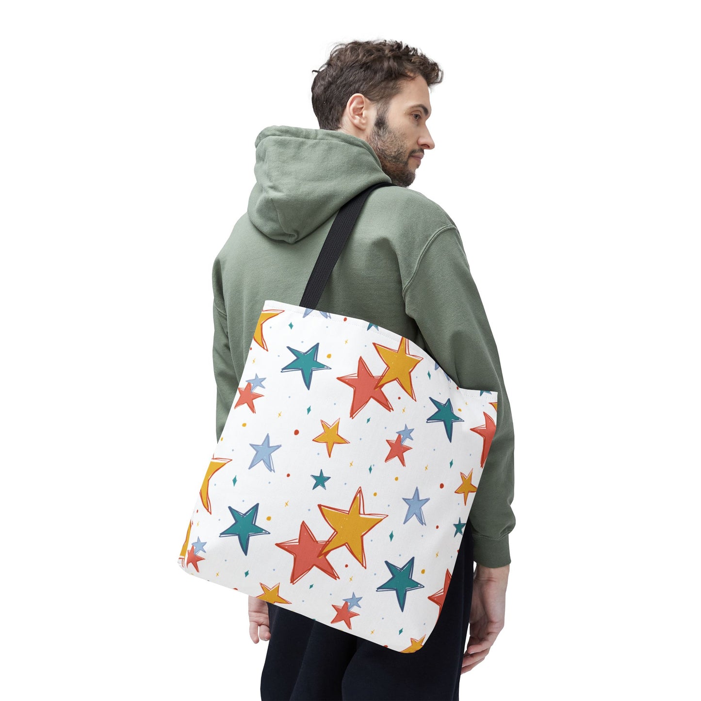 Man carrying a tote bag with colorful star pattern on a white background