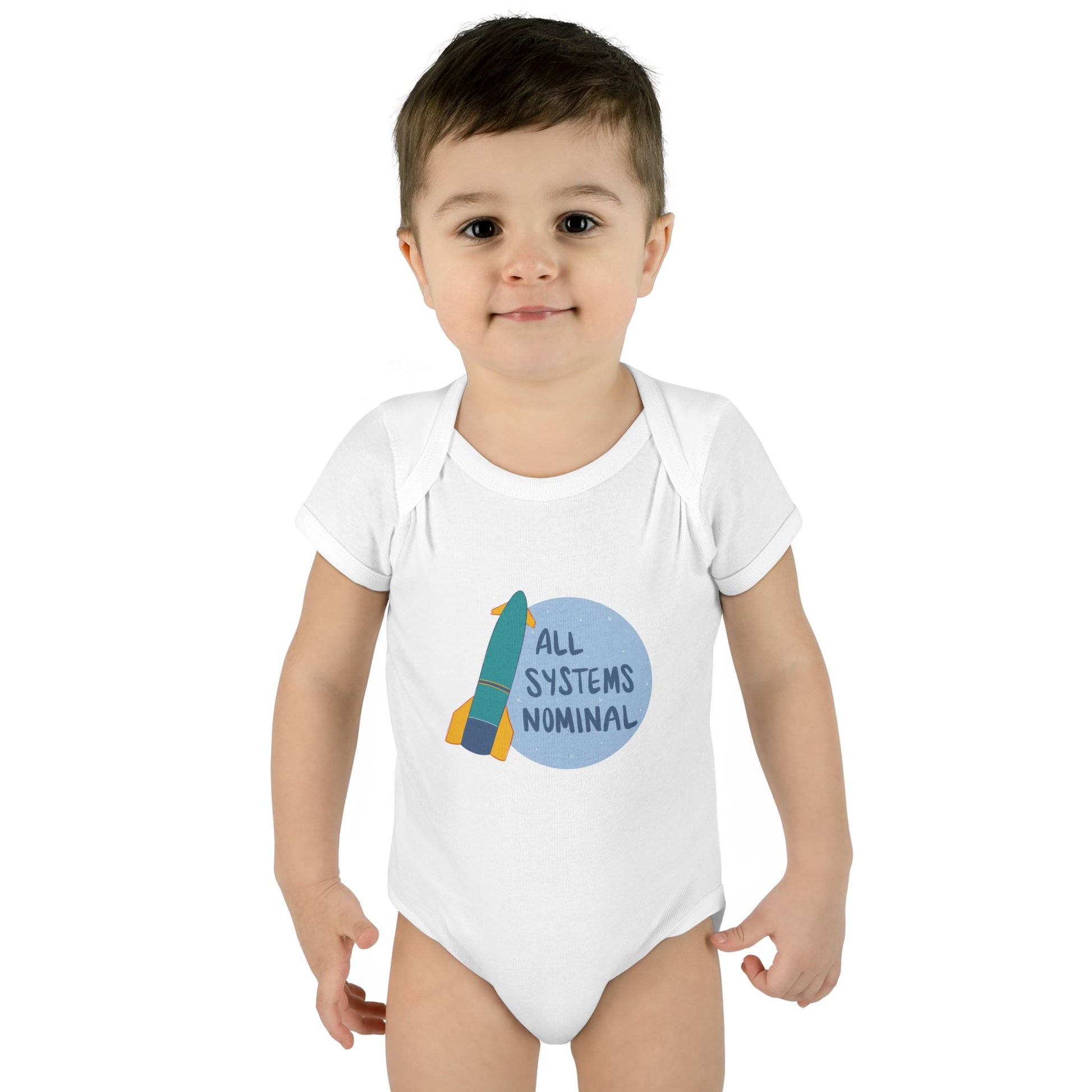 Child wearing a white onesie with a rocket and 'All Systems Nominal' graphic on a white background