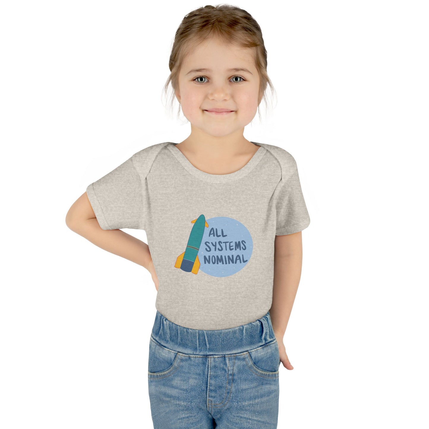 Child wearing a grey onesie with a rocket and 'All Systems Nominal' graphic on a white background