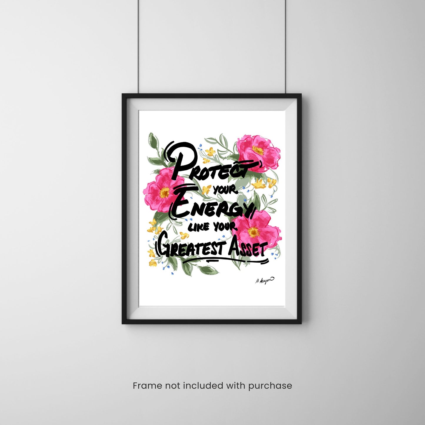 Framed print with floral design and motivational quote on a gray wall.