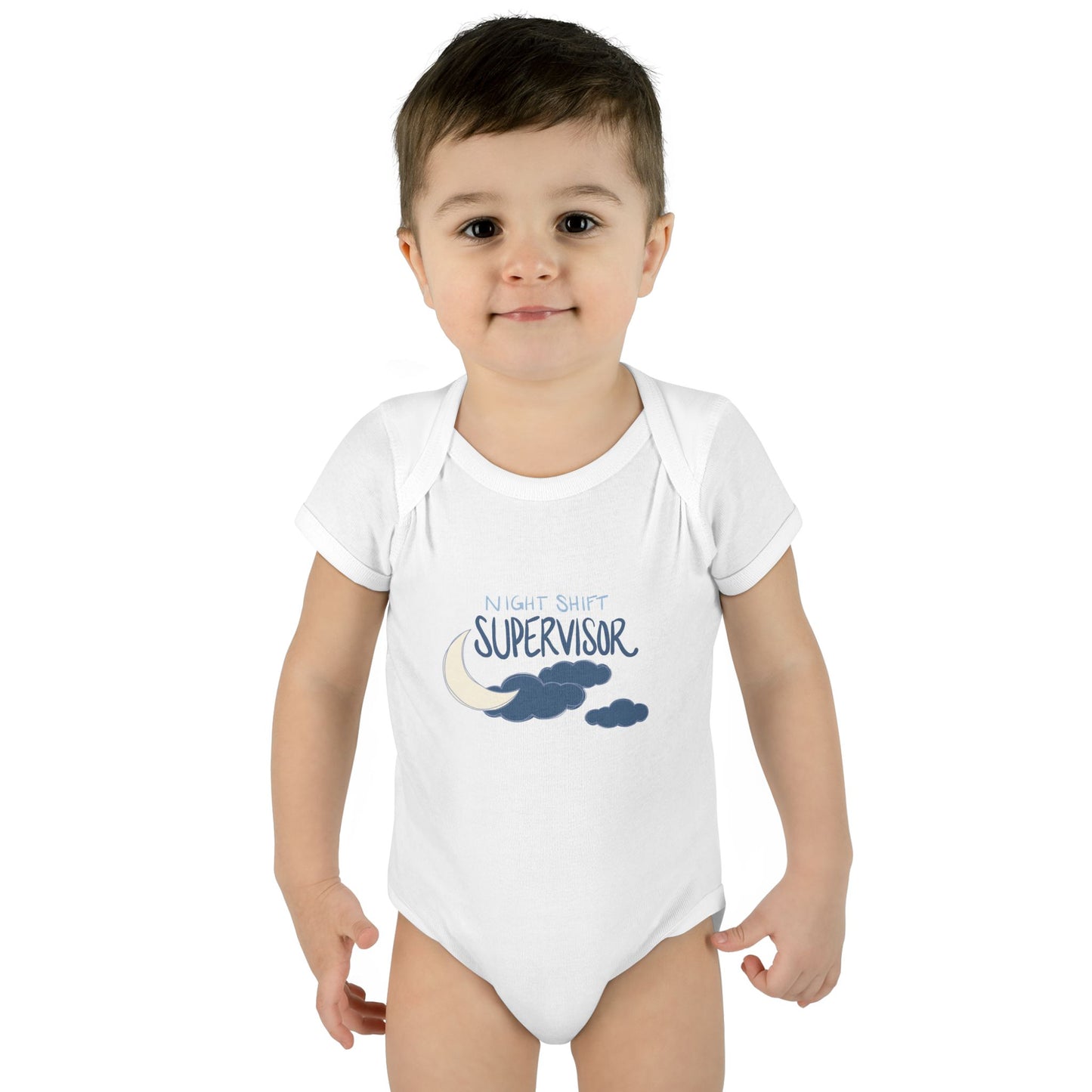 Child wearing a white onesie with 'Night Shirt Supervisor' text and cloud design on a white background